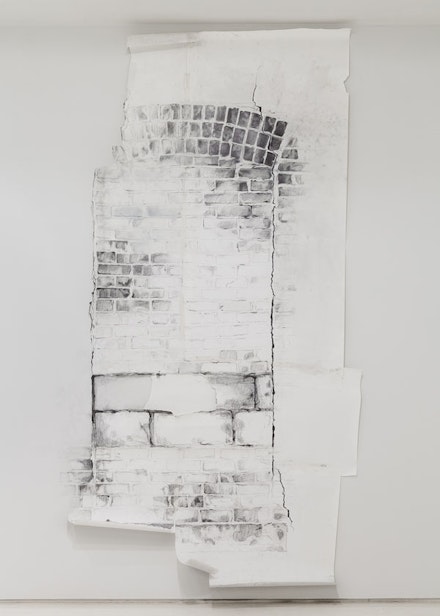 Sonya Blesofsky, “Renovation: Brick Window,” 2013. Graphite, house paint, tape on paper and wall 128 x 60 x 3”. Image courtesy of the artist and Mixed Greens Photo: Etienne Frossard.