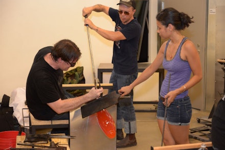 Artists at work blowing glass In UrbanGlass's newly renovated studios. Credit: UrbanGlass.
