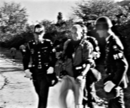 Chris Marker being arrested by military police outside the Pentagon in Arlington, Virginia, 1967, from <em>Words Not Spent Today Buy Smaller Images Tomorrow: Essays on the Present and Future of Photography </em>(Aperture, 2014). Courtesy Peter Blum Gallery, New York.
