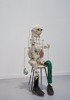 Renaud Jerez, “B” (2014). PVC, aluminum, cotton, rubber, wooden chair, webcam, and sneakers, 51 1/8 × 23 5/8 × 21 5/8˝. Courtesy of the artist and Crèvecoeur, Paris.