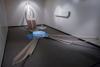 Choong Sup Lim, <em>Luna: Thousand River  & Thousand Reflections</em>, 2015. 1000 yards of traditional Korean cotton thread, rice paper, wax, wood, kinetic system, D.V.D., rocks, 12 x 15 x 9 ft. Courtesy the Korean Society. 
