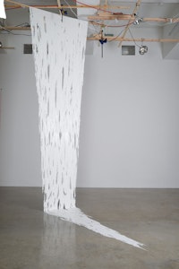 Sarah Sze, <i>Long White Paint Hanging (Fragment Series)</i>, 2015. Acrylic paint and wood bar, 145 x 112 x 52 inches. Courtesy of the artist and Tanya Bonakdar Gallery, New York. Photo: Brett Moen.
