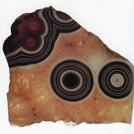 Eye agate fragment (Uruguay), from the collection of Roger Caillois (1913 – 1978). Caillois’s self-described “materialist mysticism” found perhaps its most vivid expression in his relationship to stones, and he amassed a large collection of cut and polished mineral specimens throughout his life. Their hidden structures and forms presented, Caillois believed, one of many important subjects for what he called “diagonal science,” a set of practices designed to “bridge the older disciplines and force them to engage in dialogue.” Such an approach would “[slice] obliquely through our common world [to] decipher latent complicities and reveal neglected correlations,” seeking to “further a form of knowledge that would first involve the workings of a bold imagination and be followed, then, by strict controls, all the more necessary insofar as such audacity tries to establish ever riskier transversal paths.”