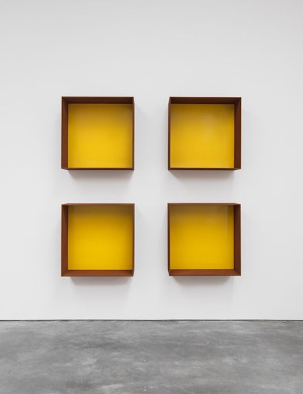 Donald Judd, <em>Untitled</em>, 1991. Cor-ten steel and yellow paint. Four units, each: 39 3/8 x 39 3/8 x 19 11/16 inches. Art © Judd Foundation. Licensed by VAGA, New York, NY; courtesy David Zwirner, New York/London.