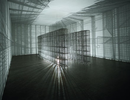 Mona Hatoum, <em>Light Sentence</em>, 1992. Galvanized wire mesh lockers, electric motor and light bulb. 198 x 185 x 490 cm. Centre Pompidou, Musée National d’Art Moderne, Paris: Mnam-CCI / Dist RMN-GP. Photo: Philippe Migeat. © Mona Hatoum.
