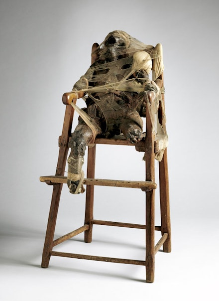 Bruce Conner, <em>CHILD</em>, 1959. Wax, nylon, cloth, metal, twine, and high chair. The Museum of Modern Art, New York. © 2016 Bruce Conner / Artists Rights Society (ARS), New York. Digital image © 2016 The Museum of Modern Art. Photo: John Wronn.