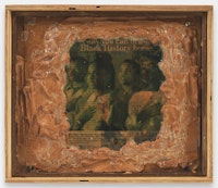 Pope.L, <em>Truth and Time a.k.a. Now You Can Bring Black History Home</em>, 1994. Gel medium, magazine photos and peanut butter on plywood with thumbtacks in plywood container. 13 1/8 by 15 1/4 by 3 in. © Pope.L. Courtesy of the artist and Mitchell-Innes & Nash, NY.