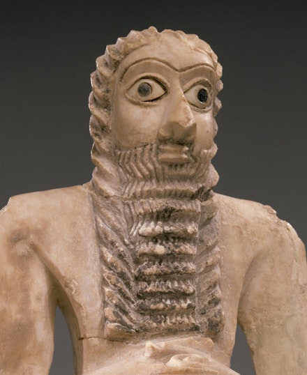 <em>Standing Male Worshiper</em> (detail), Sumerian, ca. 2900-2600 B.C. Gypsum alabaster, shell, black limestone, bitumen, 11 5/8 x 51/8 x 3 7/8 in. Courtesy of the Metropolitan Museum of Art.
