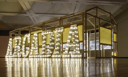<p>Ellen Harvey, <em>Arcade/Arcadia</em>, (2011-2012), Wood frame, aluminum letters, light bulbs, and 34 hand-engraved Plexiglass mirrors over Lumisheets. Courtesy the artist and Danese/Corey.</p>