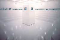 Adrian Piper, <em>What It’s Like, What It Is #3</em>, 1991. Video (color, sound), constructed wood environment, four monitors, mirrors, and lighting, dimensions variable. Installation view in Dislocations, The Museum of Modern Art, New York, October 20, 1991–January 7, 1992. © Adrian Piper Research Archive Foundation Berlin.
