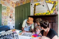 <p>Artist Xenobia Bailey, and visitors in the main room, same as living room, of the Historic Hunterfly Road House's 1860s at Weeksville Heritage Center, 2014. Image courtesy Weeksville Heritage Center.</p>
