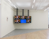 Sable Elyse Smith, <em>Room One: The Watcher</em>, 2018. 6-channel synchronized video, monitors, sound, custom floor, paint in timid white, dimensions variable. Courtesy JTT New York.