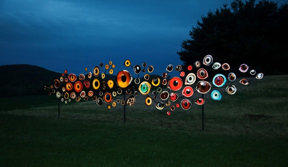 Jenny Kendler, Birds Watching, 2018. Printed reflective film mounted on aluminum with steel frame, 120 x 480 x 10 inches. Part of <em>Indicators: Artists on Climate Change</em>, Storm King Art Center. Depicts 100 eyes of bird species threatened or endangered by climate change. Courtesy of the artist.