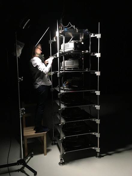 Kate Lewis working on the installation of Teiji Furuhashi, <em>Lovers</em>, 1994, Computer controlled, five-channel laser disc/sound installation with five projectors, two sound systems, two slide projectors, and slides (color, sound). The Museum of Modern Art, New York. Gift of Canon Inc., 1998. © 2019 DUMB TYPE. Photo: Ben Fino-Radin.