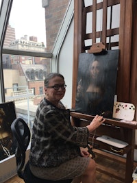 Diane Modestini in studio with Leondaro Da Vinci's <em>Salvator Mundi.</em>