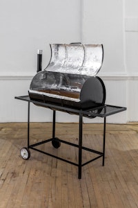 Devin Kenny,<em> Do You Even Talk To Your Neighbors?</em>, 2018. 35-gallon drum grill, photographs, documents, cellular phones, aluminum foil, 56 x 18 1/2 x 52 inches. Courtesy the artist.