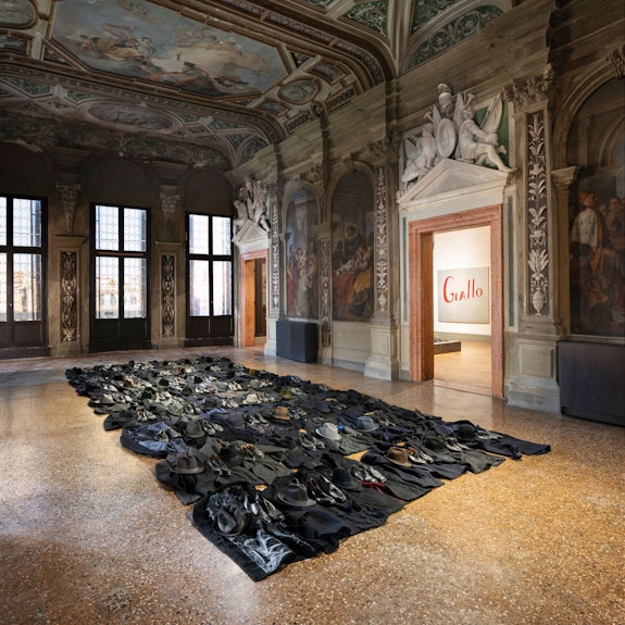 Jannis Kounellis, Untitled, 2011. Coats, hats, shoes. Courtesy Fondazione Prada. Photo: Agostino Osio - Alto Piano.