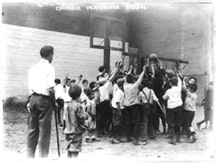 <i>Group of boys playing basketball at Carnegie Playground, 5th Ave., New York City, August 1911. Photo Courtesy George Grantham Bain Collection, Library of Congress.</i>