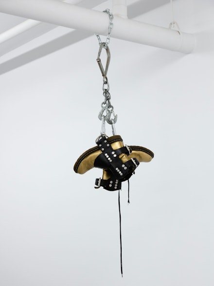 Tiona Nekkia McClodden, <em>TNM_ [The Brad Johnson Tape, X - On Subjugation]</em>, 2014-17. Gold boots, leather harness, steel chain, steel suspension hooks, 47 x 14 x 14 inches. Courtesy the artist and Company Gallery, New York.