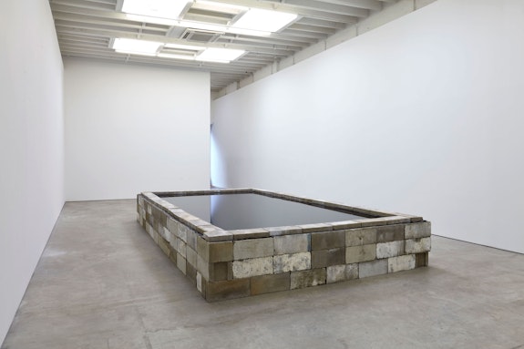 Robert Grosvenor, Untitled, 2020. Concrete blocks, rubber liner, water, 216 x 120 x 36 inches. Courtesy the artist and Karma, New York.