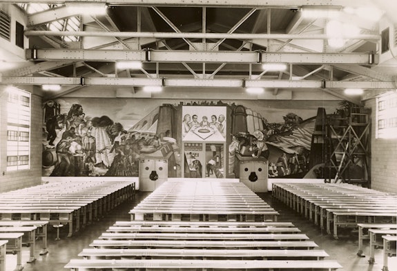 Figure 1: Installation view of <em>Man's Daily Bread</em> by Harold Lehman, Mess Hall, Rikers Island Penitentiary. Photograph by Shalat, January 20, 1941. (Mural destroyed in 1962). Collection of the Public Design Commission of the City of New York. For the 1939 New York World's Fair, the American Arts Today pavilion commissioned Lehman to create replicas of two details from his Rikers project. One of the details is modeled after the figure in the lower right corner. <em>The Driller</em>, 1937, is in the collection of the Smithsonian American Art Museum and is currently on loan to the Whitney Museum of American Art for the exhibition, <em>Vida Americana: Mexican Muralists Remake American Art, 1925-1945.</em>