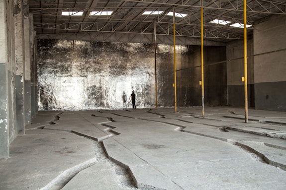 Michael Joo, <em>Locale Inscribed (Walking in the desert with Eisa towards the sun, looking down)</em>, 2014-2015. Intervention in existing site and silver nitrate. Commissioned by Sharjah Art Foundation. Installation view, Port of Sharjah, U.A.E., Sharjah Biennial 12, Sharjah, UAE. Photo: Deema Shahin.