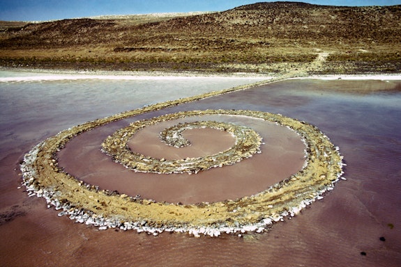 Robert Smithson, <em>Spiral Jetty</em>  (1970). Great Salt Lake, Utah. Mud, precipitated salt crystals, rocks, water. 1,500 ft. (457.2 meters) long and 15 ft. (4.6 meters) wide. Collection of Dia Art Foundation. Photograph: Gianfranco Gorgoni. © Holt/Smithson Foundation and Dia Art Foundation, Licensed by VAGA at ARS, New York.