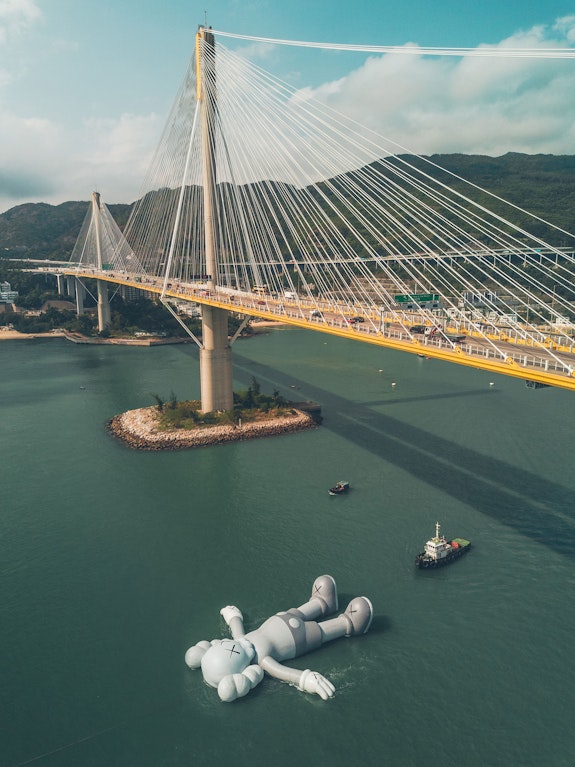 KAWS, <em>HOLIDAY</em>, 2019. Inflatable. Approximately 121 feet long. Victoria Harbour, Hong Kong. © KAWS. Photo: @5.12, courtesy AllRightsReserved, Ltd. Courtesy the artist.