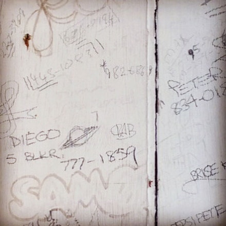 Detail from a wall scrawled with phone numbers including Diego's. Courtesy Kate McCamy. 