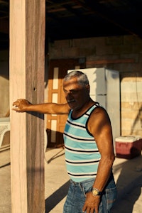 “Victor ‘Bitin’ Torres” poses for a portrait on the property he has lived on since the 1960s.