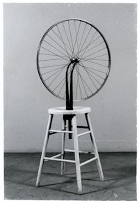 Marcel Duchamp, <em>Bicycle Wheel</em>, 1950 (replica of work from 1913 made by Sidney Janis). Bicycle fork and rim turned upside down and mounted into a kitchen stool, 50 1/2 x 25 1/2 inches. Museum of Modern Art, New York; Sidney and Harriet Janis Collection. © Association Marcel Duchamp / ADAGP, Paris/ Artists Rights Society (ARS), New York 2021.