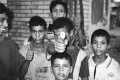 Child with toy gun in Baghdad, August 2003. Photo by Christian Parenti.