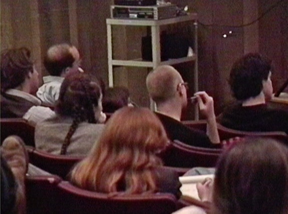 1991 CalArts lecture audience. Still from video by Josephine Meckseper. 