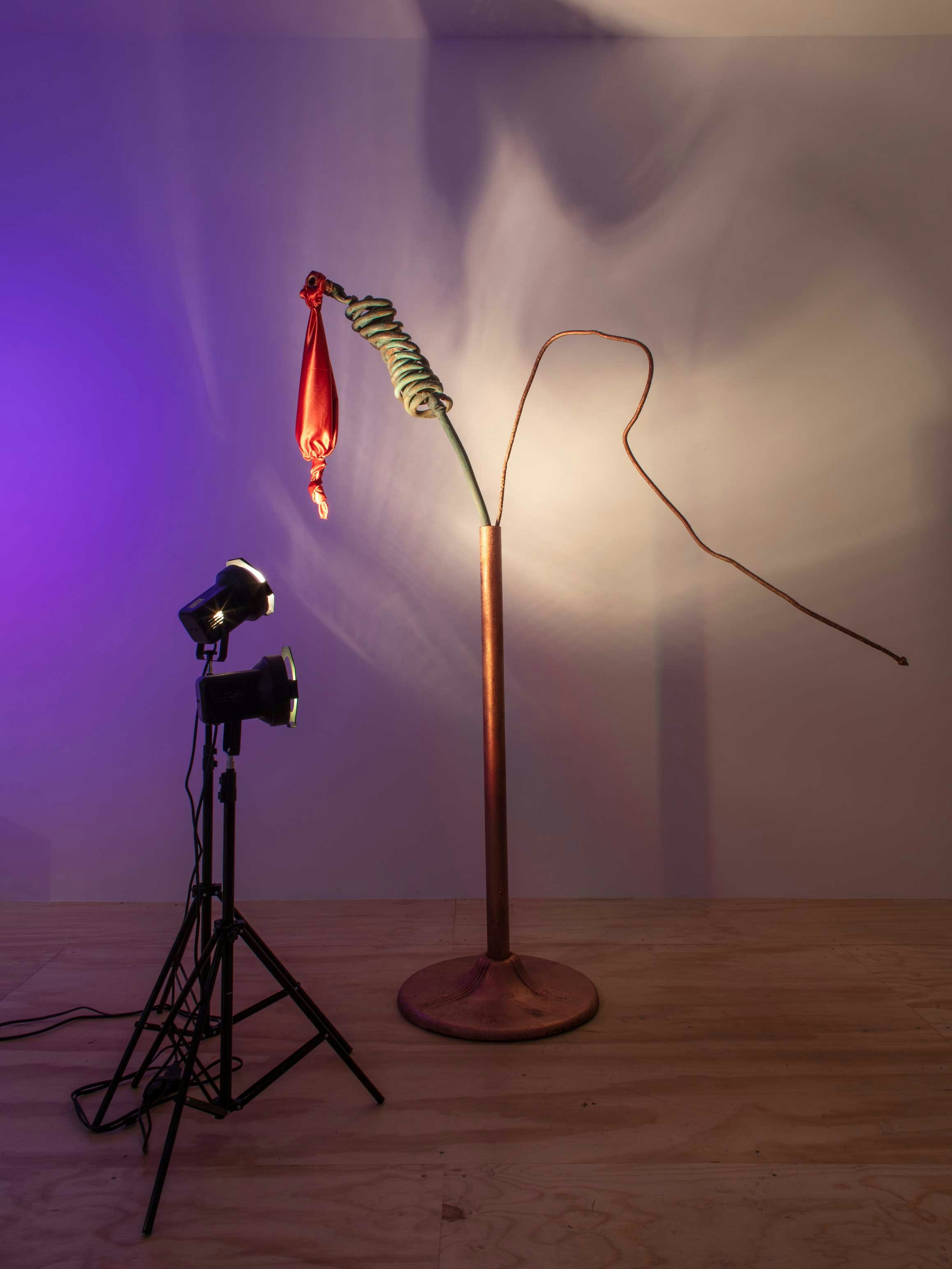Sahra Motalebi, <em>Resonator #1 (404)</em>, 2022. Copper, satin, speaker, spray paint, steel, led bulbs, lights and stands, dimensions variable. Courtesy the artist and Brief Histories, New York.