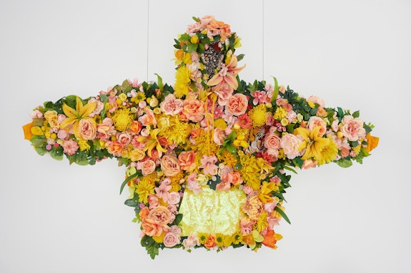 Devan Shimoyama, <em>February II</em>, 2019. Silk flowers, rhinestones, jewelry, sequins, and embroidered patch on cotton hoodie with steel armature, coated wire and fishing line, 45 x 72 x 12 inches. Courtesy Private Collection and De Buck Gallery, New York. Photo: Phoebe dHeurle.