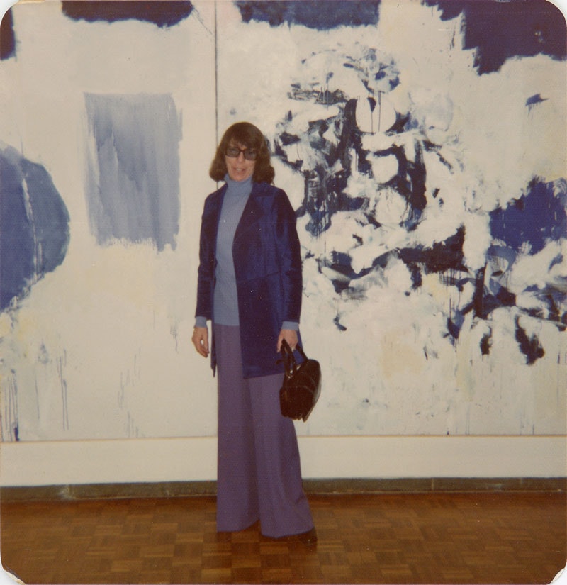Joan Mitchell at the opening of the exhibition <em>Joan Mitchell</em> at the Whitney Museum of American Art, New York, 1974. Photographer unknown, Joan Mitchell Foundation Archives. The artwork visible in the photo is <em>Les Bluets</em>, 1973 which is in the collection of the Centre Pompidou, Paris.