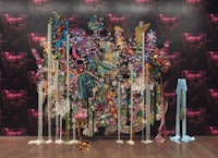 Ebony G. Patterson,<em> ...in the lament...there is a nest...a bursting a...nourishing</em>, 2021–22. Hand-cut jacquard woven photo tapestry with appliqué, fabric, trim, feathers, beads, resin, glitter, wood, steel, and plastic mounted on wallpaper, 116 x 146 x 21 inches. Courtesy the artist; Hales, London and New York; and Monique Meloche Gallery, Chicago. Photo: JSP Art Photography.
