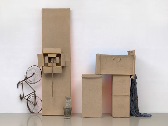Robert Rauschenberg, <em>Untitled (Early Egyptian)</em>, 1973. Sand and acrylic on cardboard with bicycle, fabric, twine, metal bucket, and wood, 153 1/2 x 193 3/8 x 46 1/8 inches. © Robert Rauschenberg Foundation. Courtesy the foundation and Gladstone Gallery. Photo: Ron Amstutz.
