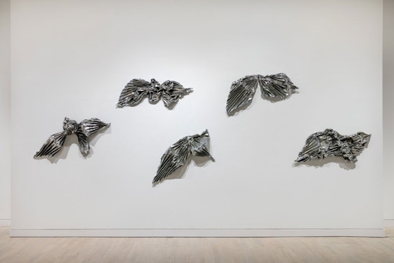 Lynda Benglis, <em>Kearny Street Bows and Fans</em>, 1985. Five bronze, nickel and chrome wall sculpture elements, each 50 x 36 inches. Courtesy the artist and Locks Gallery.