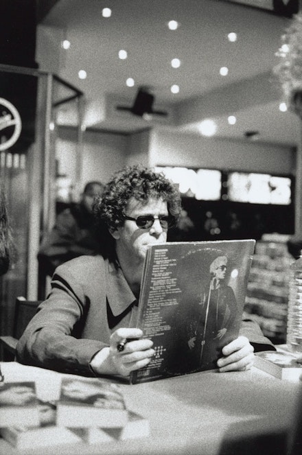 Lou Reed holding a copy of <em>Metal Machine Music</em> at an in-store signing in Paris, September 19, 1996. © Mila Reynaud. Lou Reed Papers, Music & Recorded Sound Division, The New York Public Library for the Performing Arts.