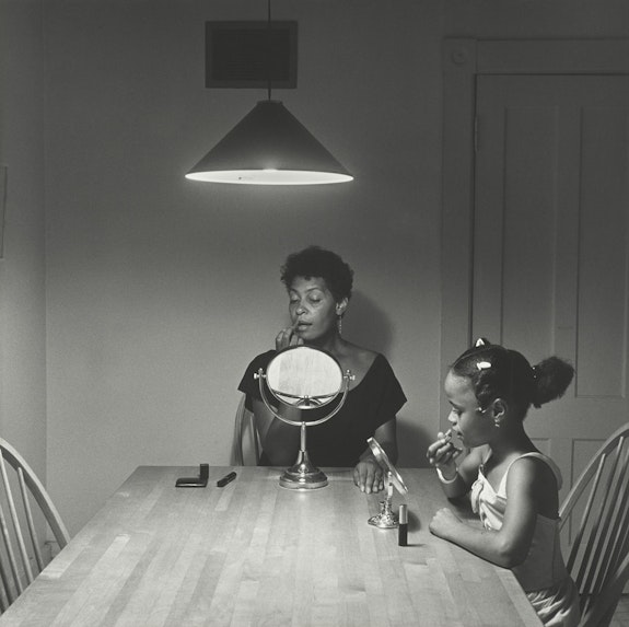 Carrie Mae Weems, <em>Untitled (Woman and daughter with makeup)</em>, 1990. Gelatin silver print, 27 3/16 × 27 3/16 inches. The Museum of Modern Art, New York. Gift of Helen Kornblum in honor of Roxana Marcoci. © 2021 Carrie Mae Weems.