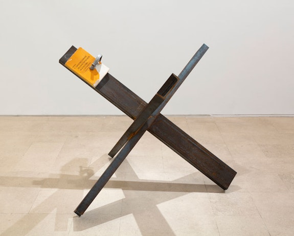 Nikita Kadan, <em>Struggle for Progressive Realism in Art in Foreign Countries</em>, 2022. Steel, clamp, book?39 1/2 x 51 1/2 x 51 1/2 in.  Courtesy Miguel Abreu Gallery.