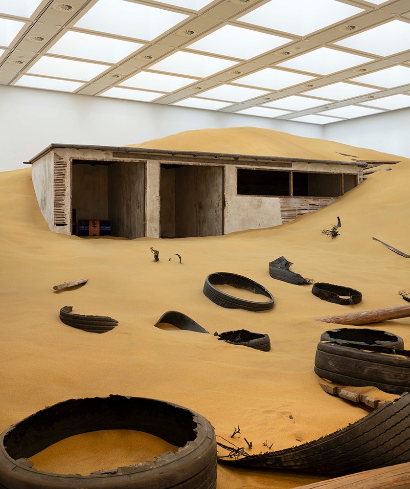 Installation view: <em>Mike Nelson, Triple Bluff Canyon (the woodshed)</em>, 2004. Various materials. M25, 2023. Found tyres. Photo: Matt Greenwood. Courtesy the artist and the Hayward Gallery.