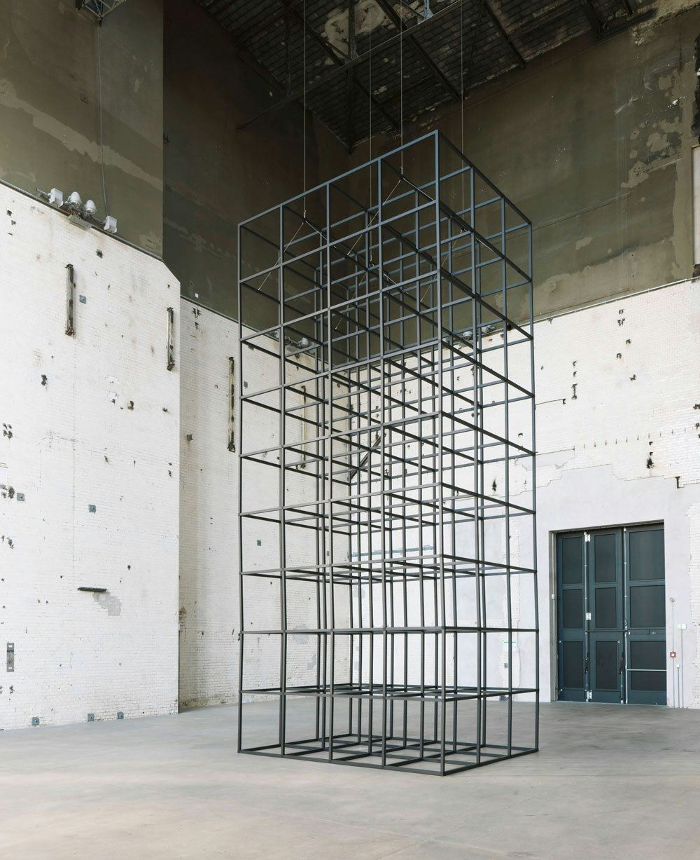 Installation view: <em>Mona Hatoum: all of a quiver</em>, KINDL – Centre for Contemporary Art, Kesselhaus, Berlin, 2022. Aluminium square tubes, steel hinges, electric motor and cable, 339 x 151 1/2 x 114 inches. Courtesy KINDL – Centre for Contemporary Art, Kesselhaus. Photo: Jens Ziehe.