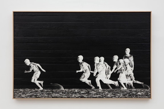 JR,<em> Les Enfants d’Ouranos, Bois #6</em>, 2022. Ink on wood, oak frame. 50 1/2 x 80 x 2 1/2 inch. ©JR. Courtesy the artist and Perrotin. Photo: Guillaume Ziccarelli. 