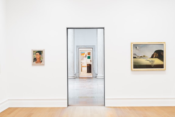 View of a gallery in the Wilmers Building with, from lef to right, Frida Kahlo, <em>Self-Portrait with Monkey</em>, 1938; Robert Rauschenberg, <em>Ace</em>, 1962; Edward Kienholz, <em>The Minister</em>, 1961; Salvador Dalí, <em>The Transparent Simulacrum of the Feigned Image</em>, 1938. Courtesy of Buffalo AKG Art Museum, OMA, Studio Other Spaces, and Cooper Robertson. Photo: Marco Cappelle.