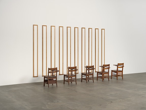 Gary Simmons, <em>Disinformation Supremacy Board</em>, 1989. Ten white boards and five desks, 104 × 154 × 50 inches. Courtesy the artist and Hauser & Wirth. © Gary Simmons. Photo: Keith Lubow.