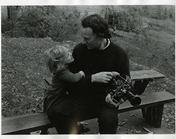 Jonas Mekas with his Bolex and a young Oona Mekas in 1977, <em>Fragments of Paradise</em>, directed by KD Davison. Courtesy the Jonas Mekas estate.
