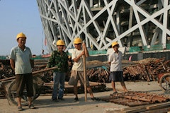 <i>Migrant workers in July 2007 at Beijing's Olympic Stadium, known as the 