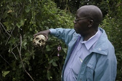 Professor Pilo inspects a skull in the killing fields of Bogoro, Ituri, eastern Congo. Photo by Susan Meiselas/Magnum Photos.